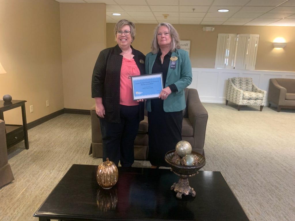 Two female employees of Miller's Senior Living pose for a picture with their Member of the Month award from the Greater Portage Chamber of Commerce.